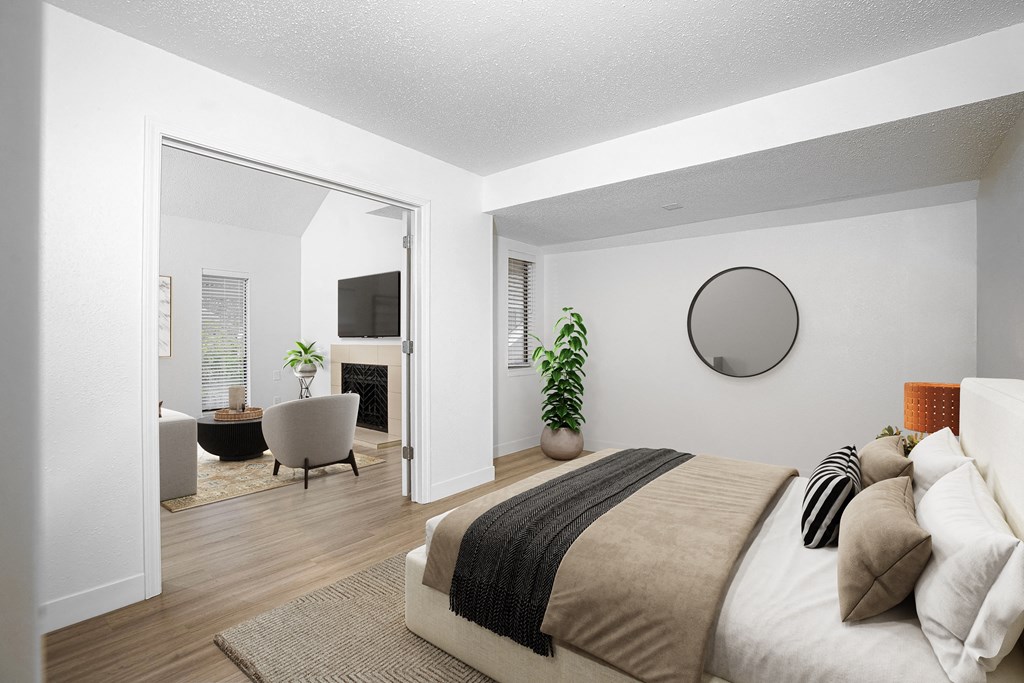 a bedroom with a bed and a bathroom with a tv